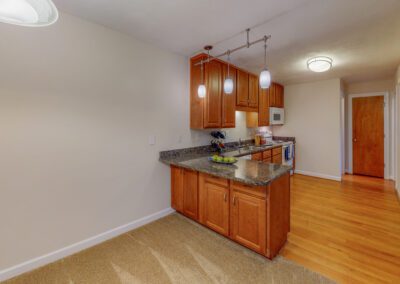 Area Combines Kitchen In Adjacent Living Spaces