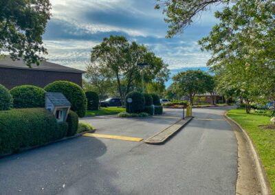 Entrance To Residential Property With Lush Green Landscaping And Trees