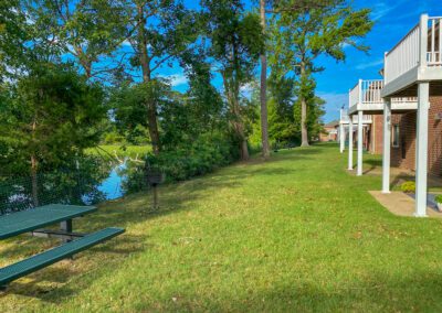 Exterior Of Apartment Building Featuring Multi-Story Units With Shared Green Space