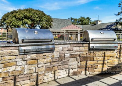 Built-In Outdoor Kitchen Area With Two Stainless Steel Grills