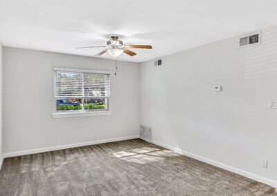 Room Featuring Light-Colored Walls & Ceiling Fan